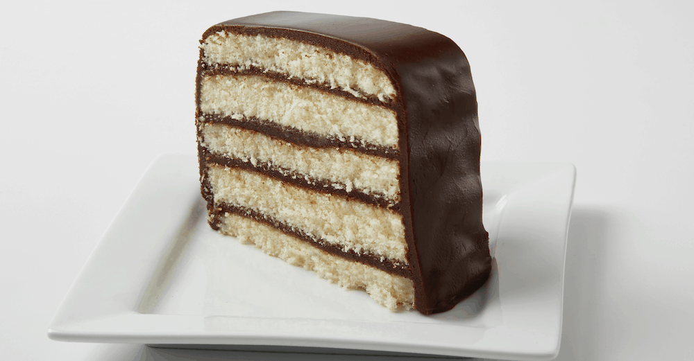 A vanilla cake with layers of chocolate frosting.
