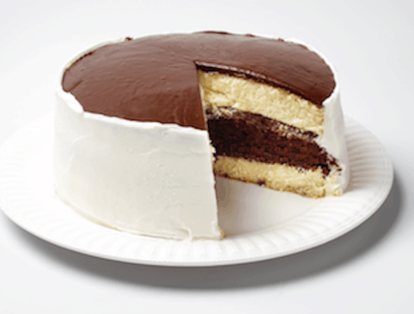 The Ukrop's Black and White cake on a plate. A slice has been removed to show the layers inside the cake.