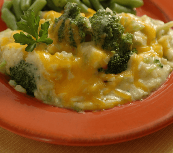 A close up shot of the Ukrop's Broccoli and Rice casserole showing broccoli and cheese.