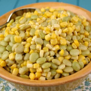 A bowl full of lima beans and corn.