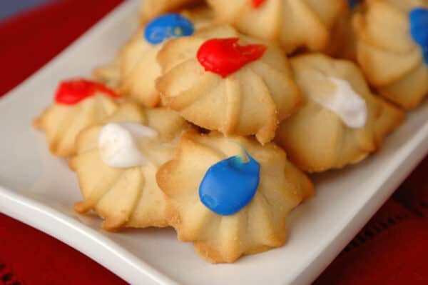 A plate of red, white, and blue colored Ukrop's Butterstar Cookies.