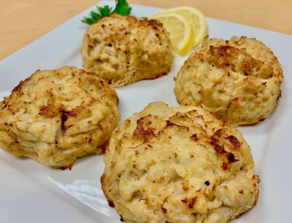Four of Ukrop's Signature Crab Cakes on a plate.