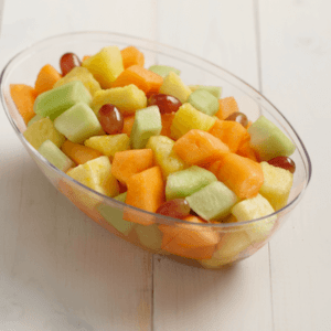 A bowl of mixed fruit including cantaloupe, honeydew, grape, and pineapple.