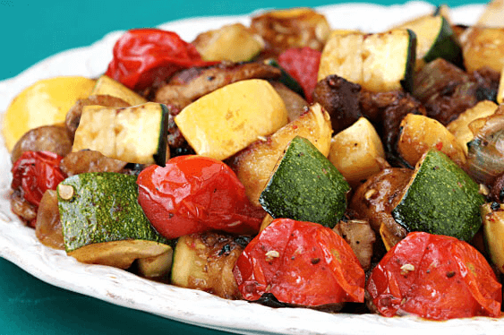 A close up of a plate full of roasted vegetables.