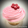 A pink iced cupcake with a flower decoration.