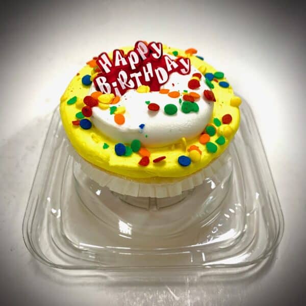 A cupcake that says "Happy Birthday" with confetti sprinkles.